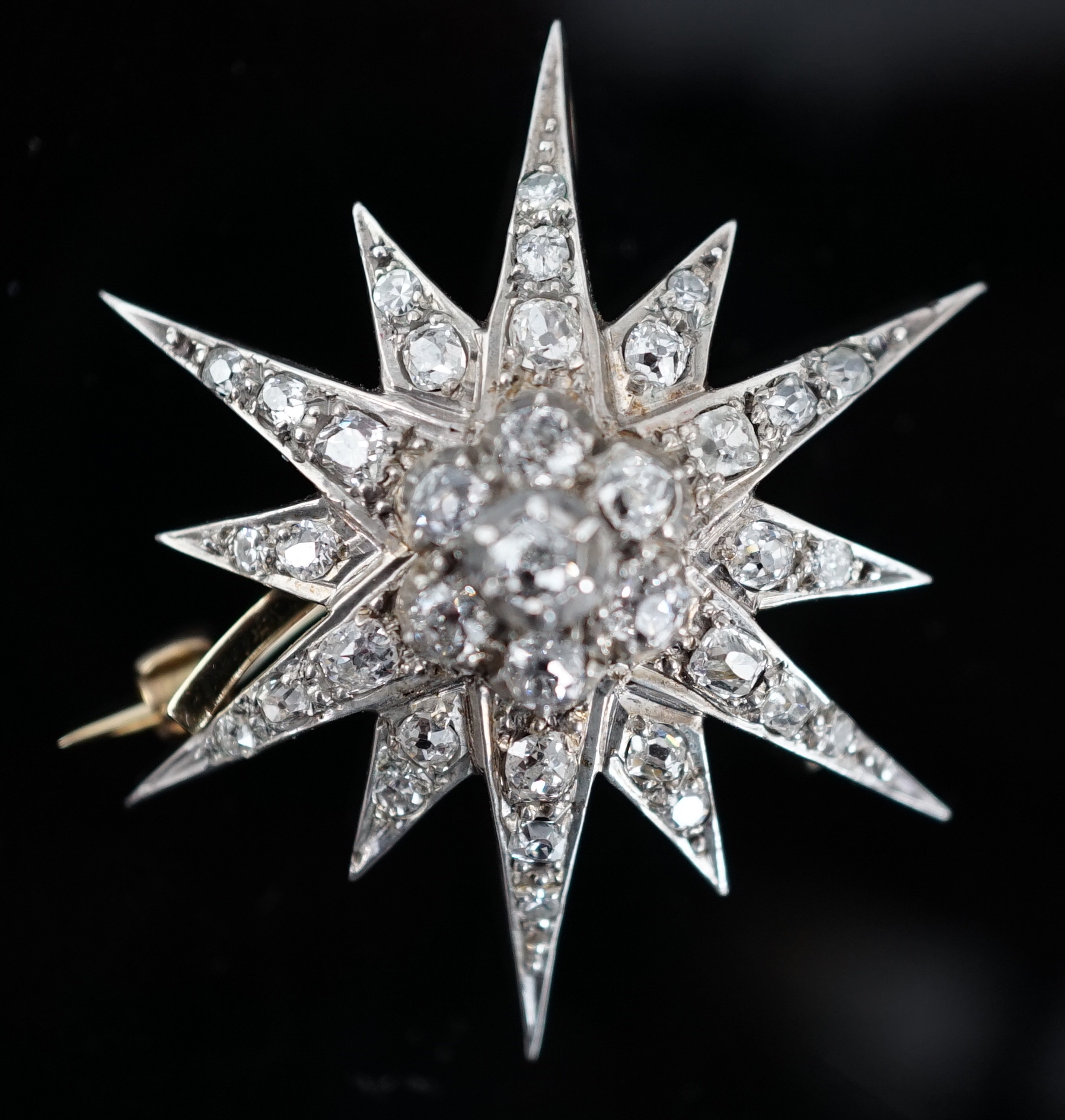 A Victorian gold, silver and graduated diamond cluster starburst brooch